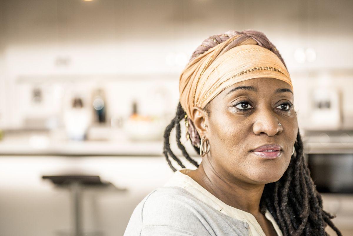 This image is of a black woman patient in deep thought or reflection.